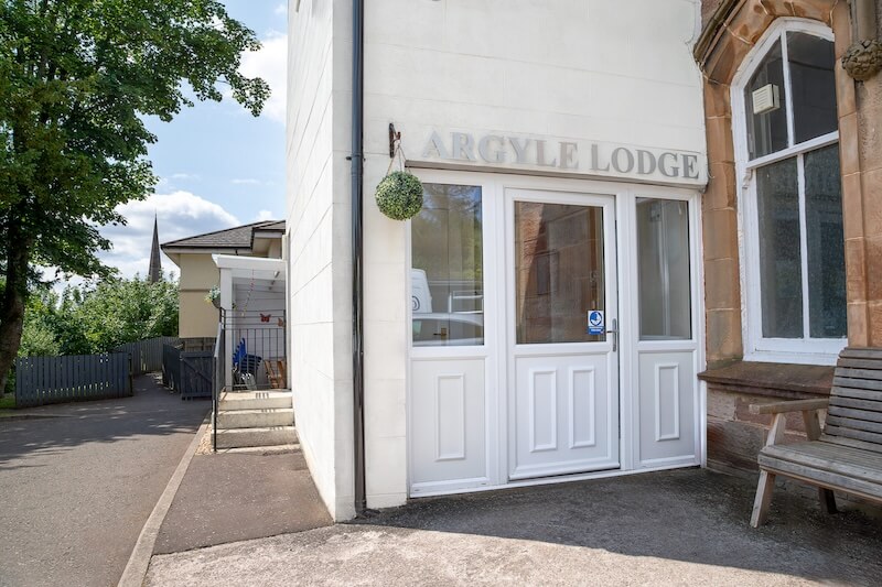 A front door with a name displayed above it.